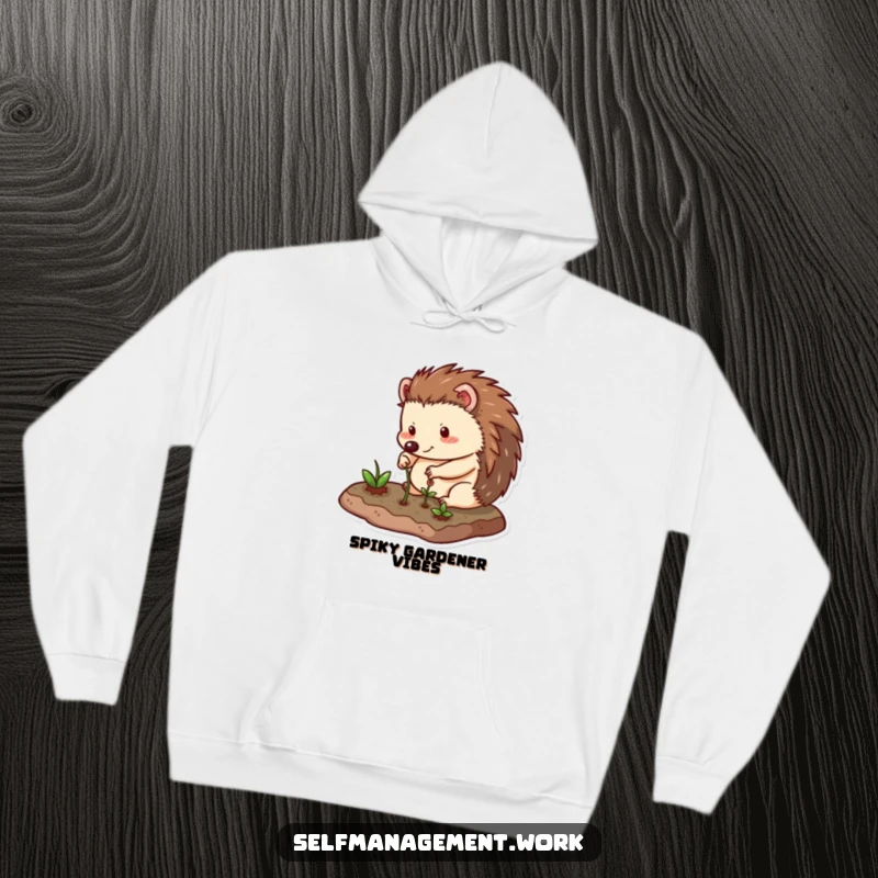 Funny Hoodie with a happy hedgehog character carefully tending to a small, neat garden plot, radiating calm and a love for green spaces.